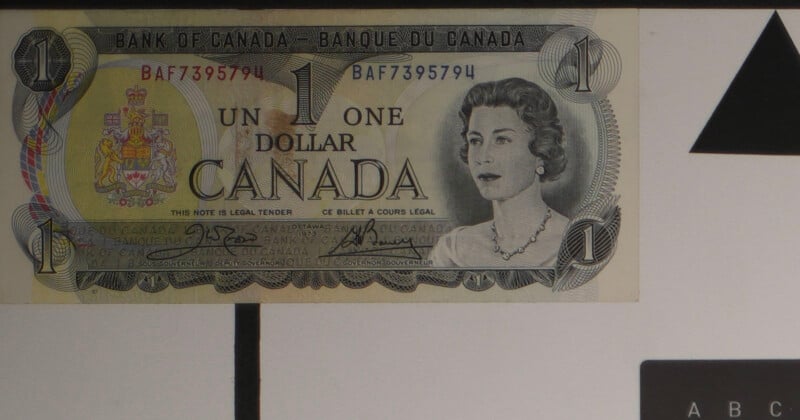 A Canadian one dollar bill featuring a portrait of a woman, the Canadian Coat of Arms, and bilingual text in English and French. The serial number BAF7395794 appears twice in red.