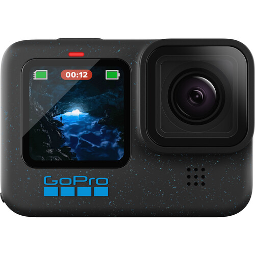 A GoPro camera with a small digital screen on the front displaying an image of a cave with water and light. The device is black with a blue GoPro logo beneath the screen. There are icons showing a battery and recording status.