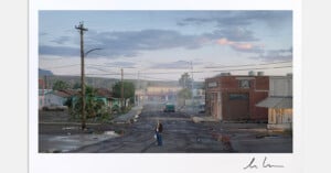 A person stands alone on a cracked, empty street in a small, deserted town at dusk, surrounded by rundown buildings and palm trees under a cloudy sky.