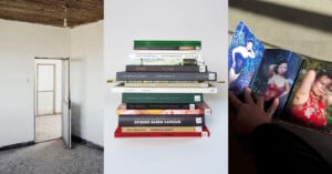 A stack of books is pictured in the center, with a bare, sunlit room on the left and a hand holding open a photo book showing a woman in a red dress on the right.
