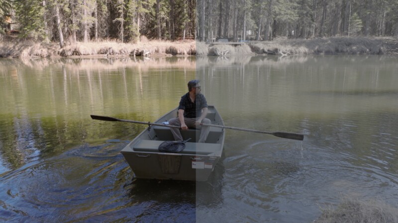 A person rows a small boat on a forested lake; the left half of the image is vibrant and colorful, while the right half is dull and desaturated, illustrating a color grading comparison.
