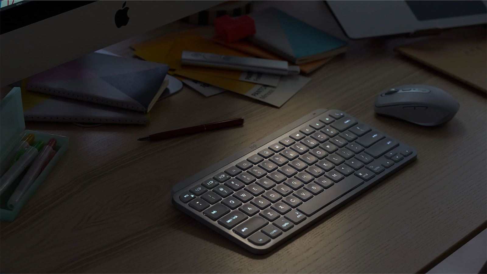 The Logitech MX Keys Mini is seen on a gear with a mouse and other items.