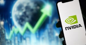 A smartphone displays the Nvidia logo in the foreground, while in the blurred background, a rising green arrow graph is overlaid on an image of Earth, symbolizing growth or an upward trend.