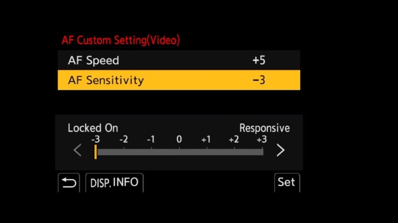 Camera menu screen showing AF Custom Setting for video. AF Speed is set to +5, AF Sensitivity is set to -3, with a scale ranging from -3 (Locked On) to +3 (Responsive). Options for DISP.INFO and Set are at the bottom.