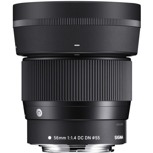 A black Sigma 56mm f/1.4 DC DN camera lens, standing upright, showing its textured focus ring and lens details printed in white on the barrel.