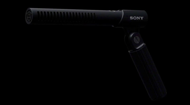 A black Sony shotgun microphone with a cylindrical body and vented grille, mounted on a handle against a black background.