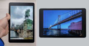 Two tablets display travel photos: the left tablet shows a statue on a bridge with a cathedral in the background, while the right tablet shows a large suspension bridge over water under a blue sky.