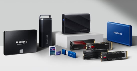 A collection of Samsung storage devices displayed on a white and gray surface, including solid state drives, portable SSDs, SD cards, and USB flash drives, all in various shapes and colors.
